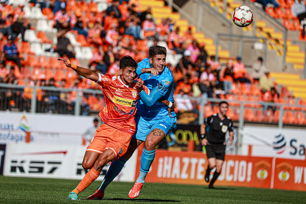 Futbolistas de Cobreloa y Deportes Iquique yendo a luchar el balón.